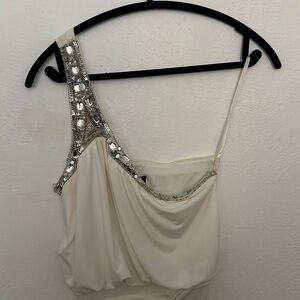 This is a white one shoulder with beaded crystals dress.
